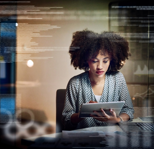 Woman sitting at desk and holding a tablet