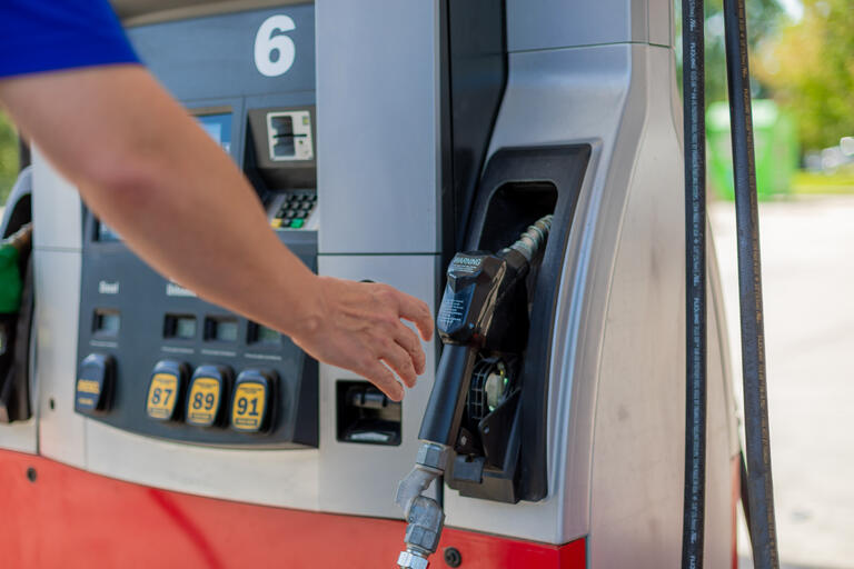 man at gas tank