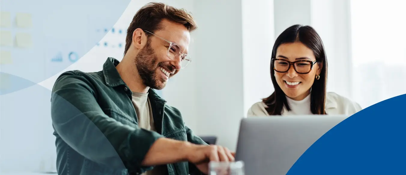 Two people reviewing the laptop