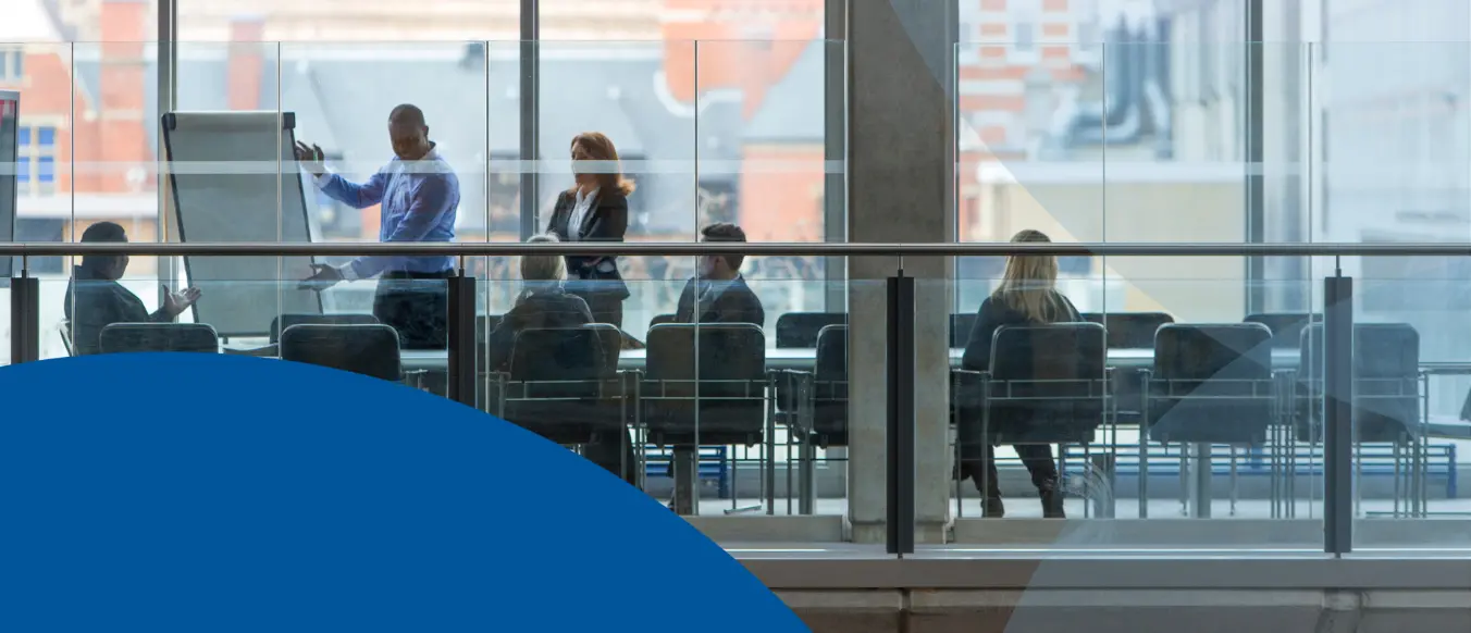 people in conference room as seen through window
