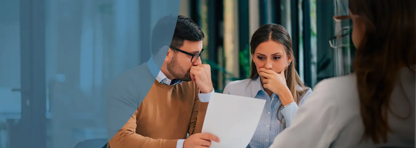 man and woman reading paper