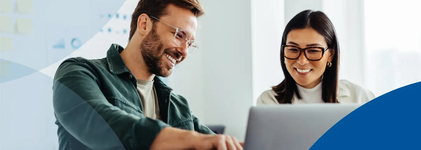Two people reviewing the laptop