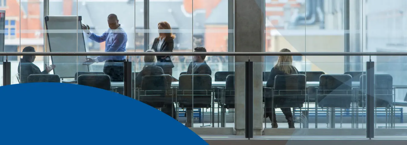 people in conference room as seen through window
