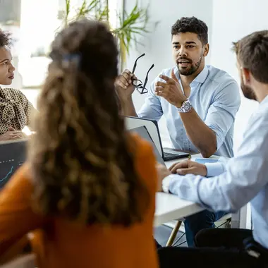 indian men speaking in a meeting