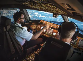 People in a cockpit manning a trip with World Fuel Trip Support