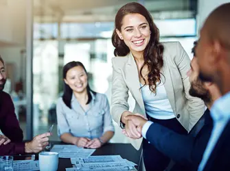 Cropped shot of two businesspeople shaking hands during a meeting in the boardroom