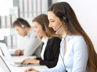 People at a desk receiving phone calls
