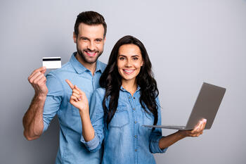Close up photo beautiful amazing she her he him his couple lady guy hold credit card notebook show simple way internet buy pay wear casual jeans denim shirts outfit clothes isolated grey background