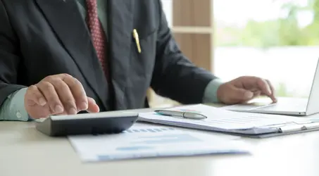 person working at desk on plan