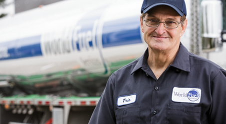 Older driver smiling at the camera wearing world fuel services uniform