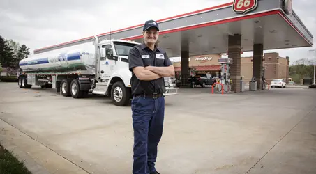 world fuel employee in front of phillips 66