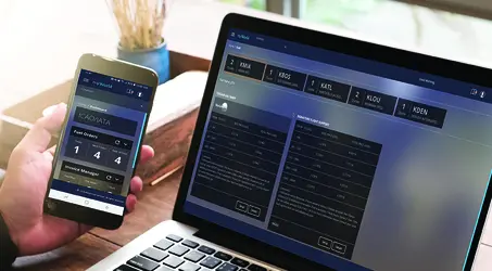 man holding phone with computer open