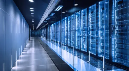 A row of servers in a data center, with lighting with the rows