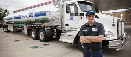 truck driver standing in front of a pump