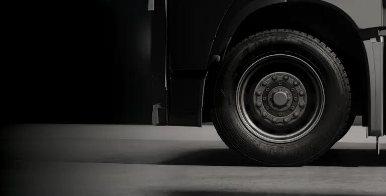 Looking at the black wheel of a large truck