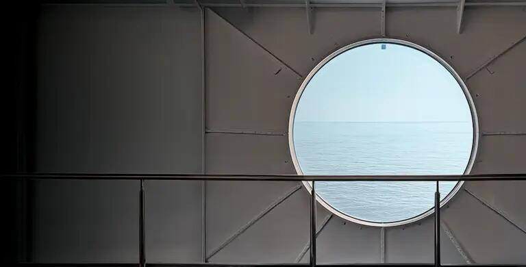 View looking through a port hole into the open ocean