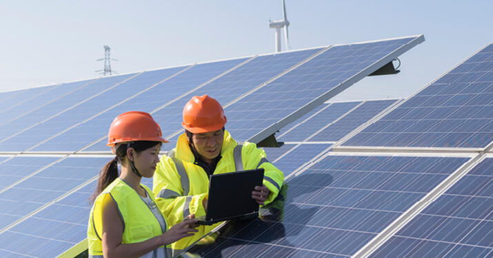 energy workers by solar panels