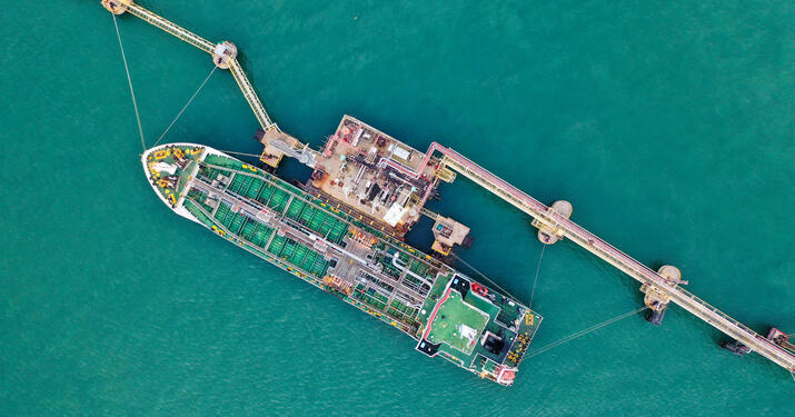 Overhead view of a container ship refueling at port