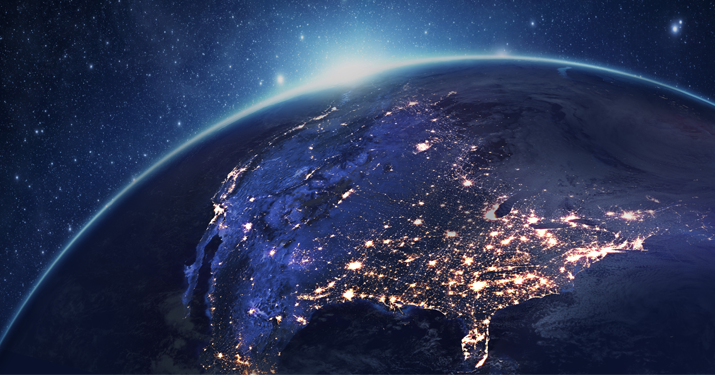 globe with sun rising behind