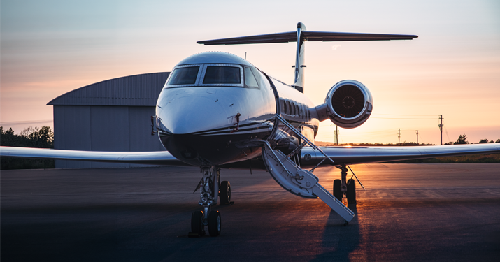 plane on tarmac at sunset