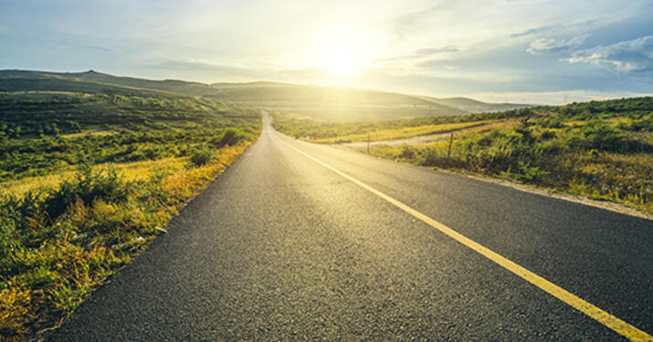 Open road with fields on either side