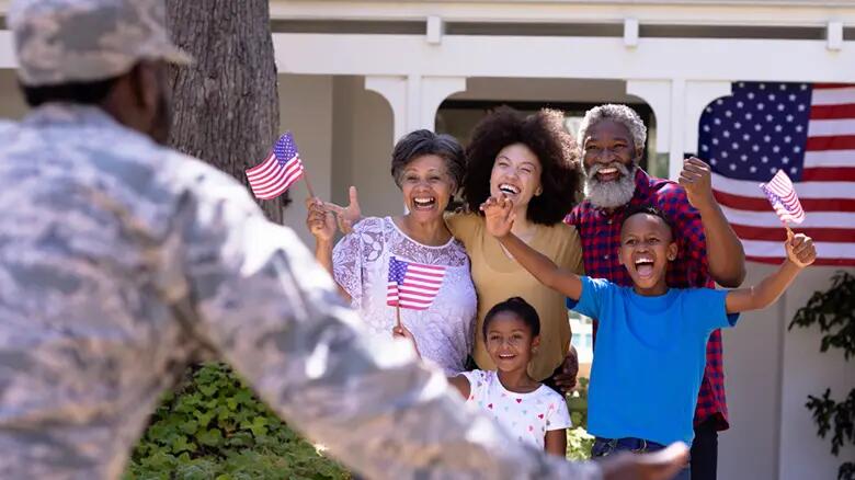Military Family Welcoming Soldier in front of their house