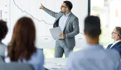 man pointing at graph