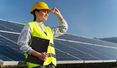 electricity expert in front of solar panels